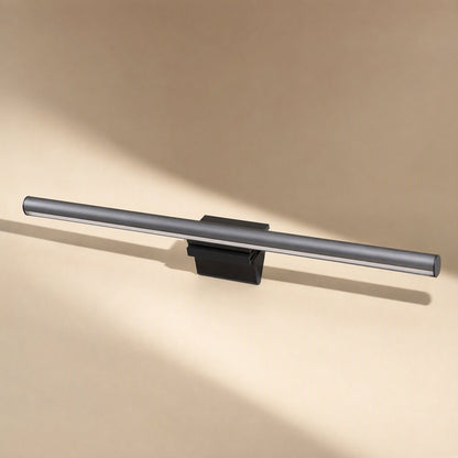 Hangglow – Side view of the slim black lamp bar and its flat clip base, with soft shadows across a peach surface