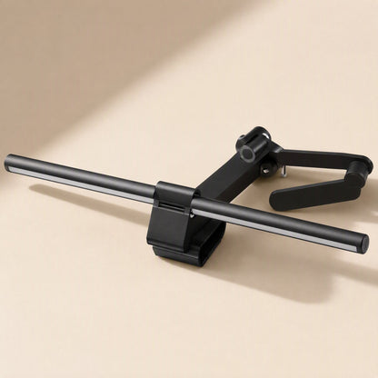 Hangglow – Lamp bar resting on its side with the counterweight arm and clip open, shown from above on a cream surface