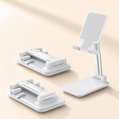 Foldangle – Two folded white stands lying flat beside one open stand with angled cradle and silver adjustable arm