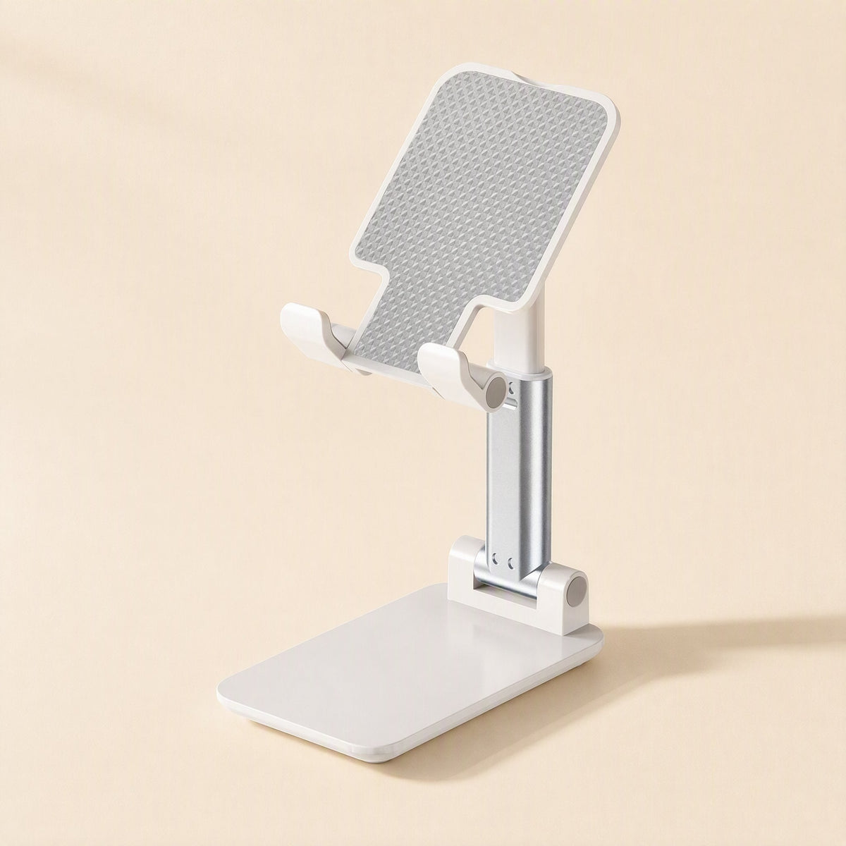 Foldangle – Front three-quarter view of the white stand with textured grey cradle, silver arm and hinged base