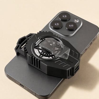 Frostdial – Black phone cooler radiator with clear fan cover clipped to the back of a gray smartphone, top-down view