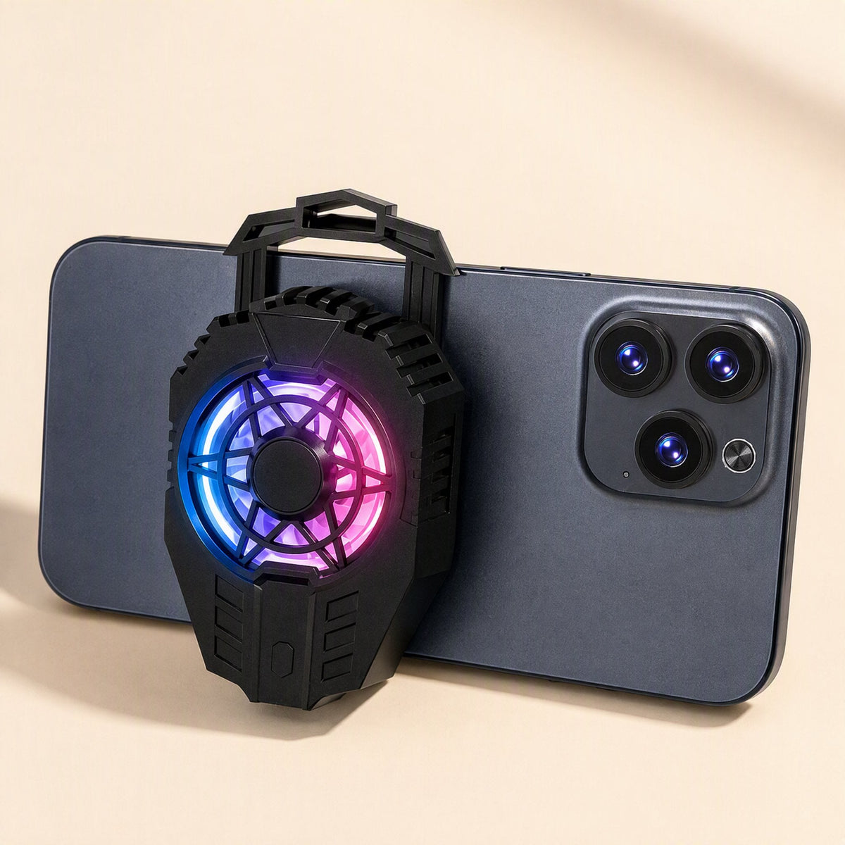 Frostdial – Phone cooler with glowing purple and blue lit fan attached to the back of a smartphone, held upright by its clip