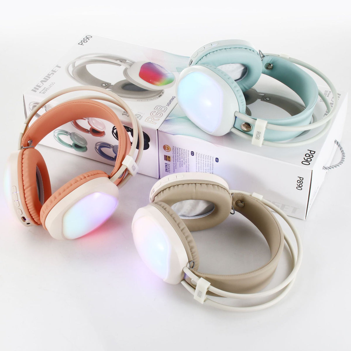 Loomvox – Peach, mint and beige headsets with glowing ear cups resting on a P890 box, seen from above