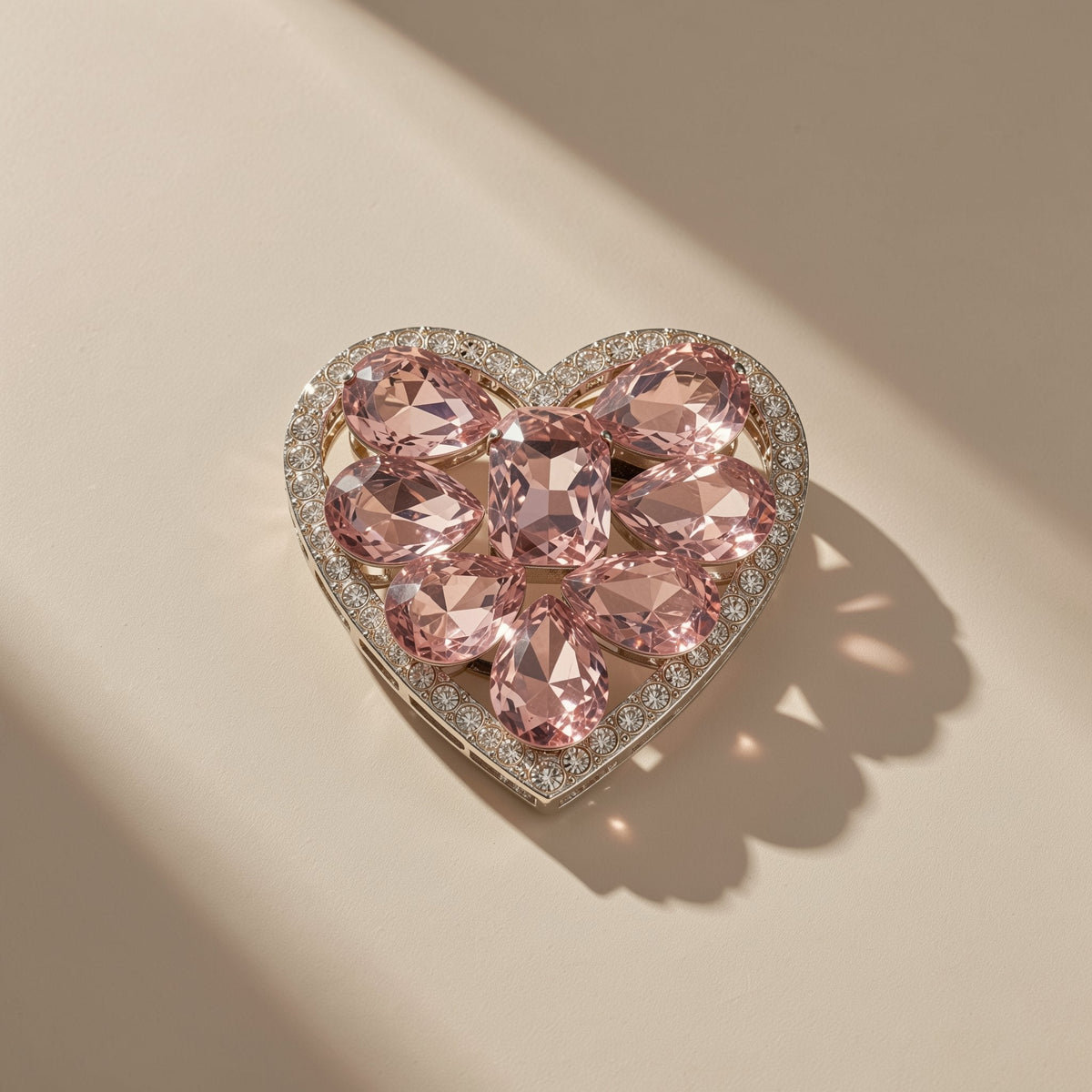 Cushgrip Magnetic Phone Airbag Holder – heart-shaped holder with pink crystals and a rhinestone border seen from above