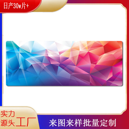 Deskglide – Wide mouse pad with a blue, pink and orange geometric low-poly pattern on a white background