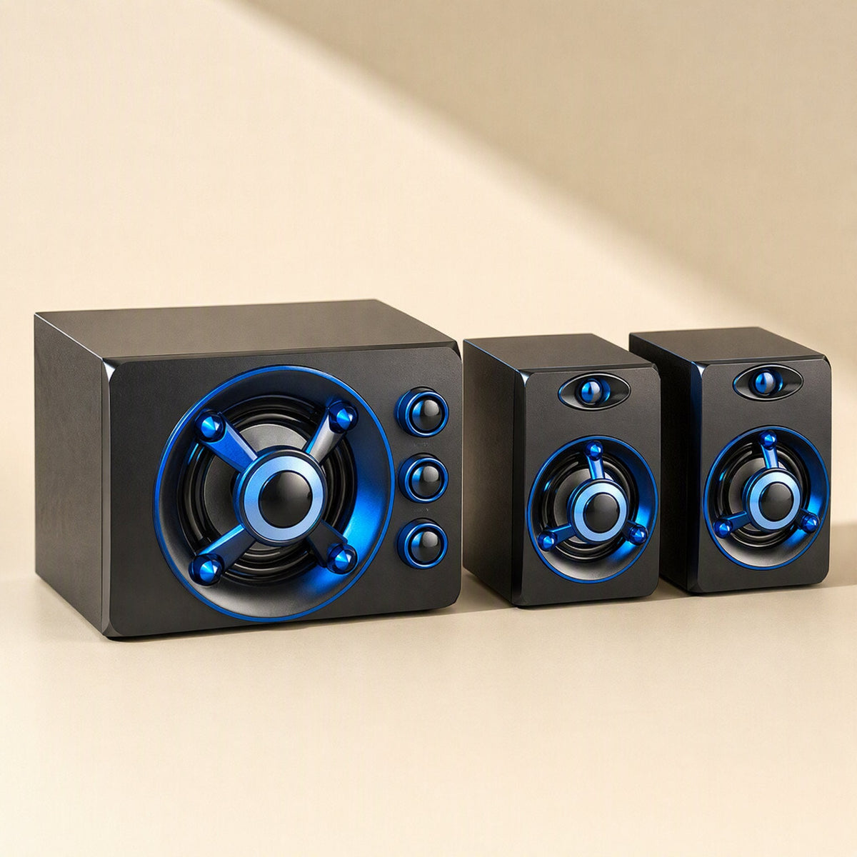 Tunespark – Side-by-side view of the subwoofer with three control knobs next to two satellite speakers, blue ring lighting