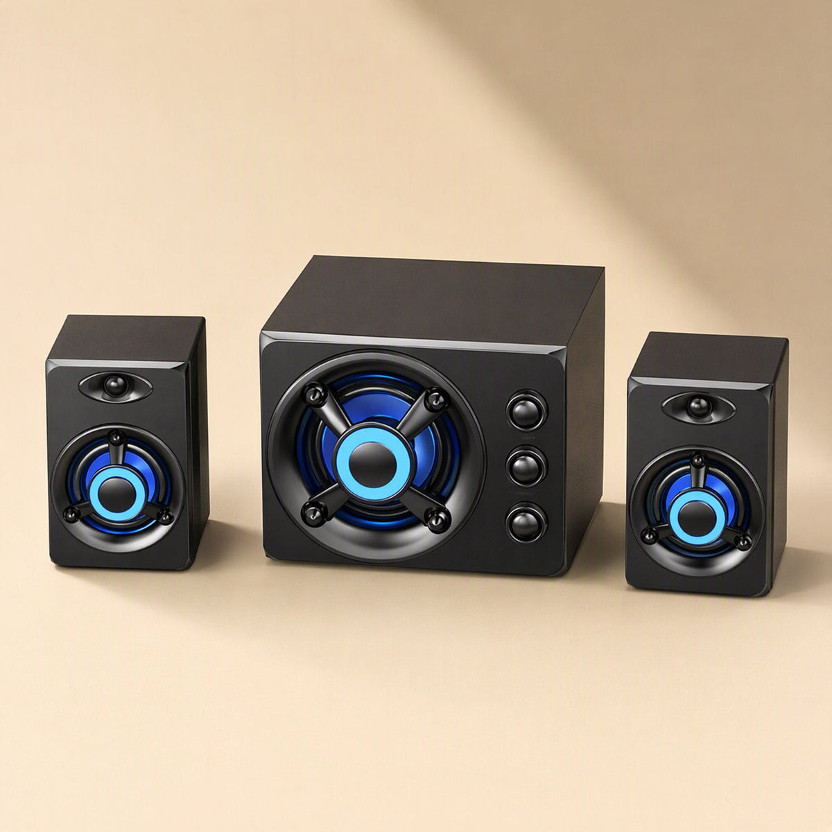 Tunespark – Front view of the speaker trio on a beige background, subwoofer between two small speakers with blue lights