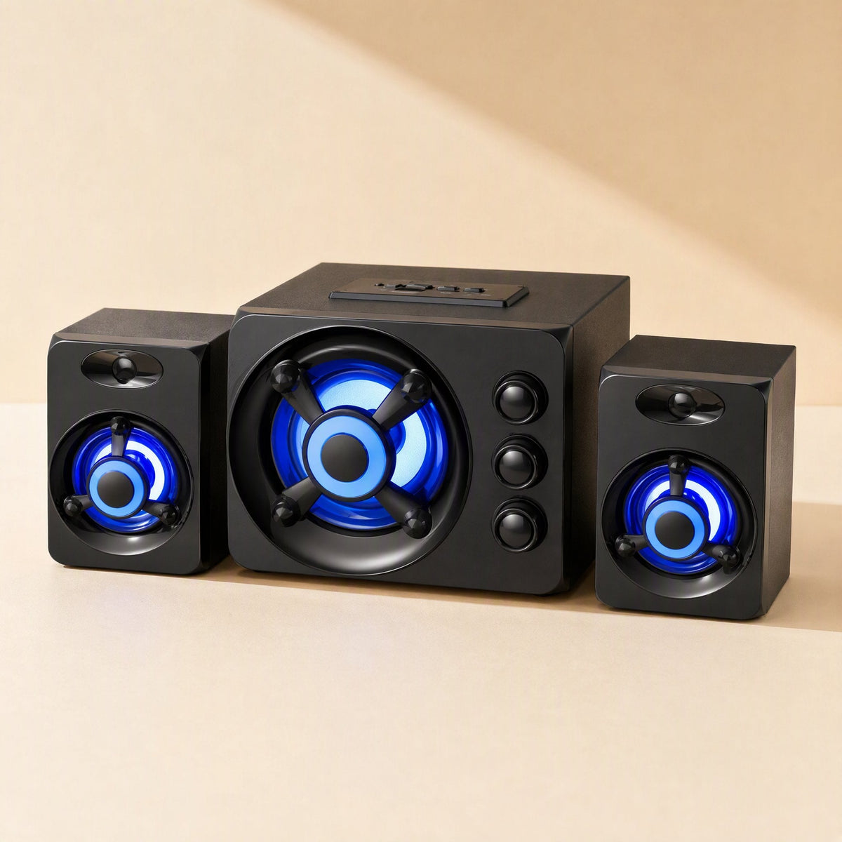 Tunespark – Front view of the subwoofer and two satellite speakers with blue glow and a control panel on top of the subwoofer