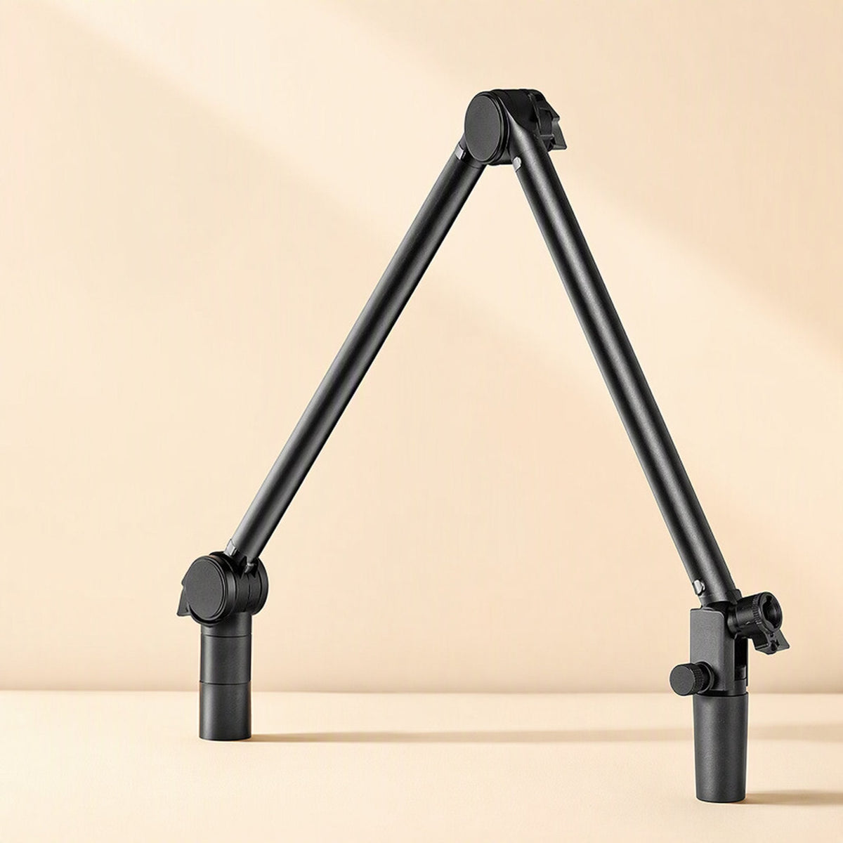 Metalreach – Foldable black mic stand arm collapsed into a tall A-shape, with both ends resting on a flat surface