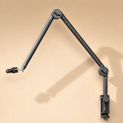 Metalreach – Black adjustable mic boom arm clamped to a wall-like surface, with a long diagonal shadow behind it