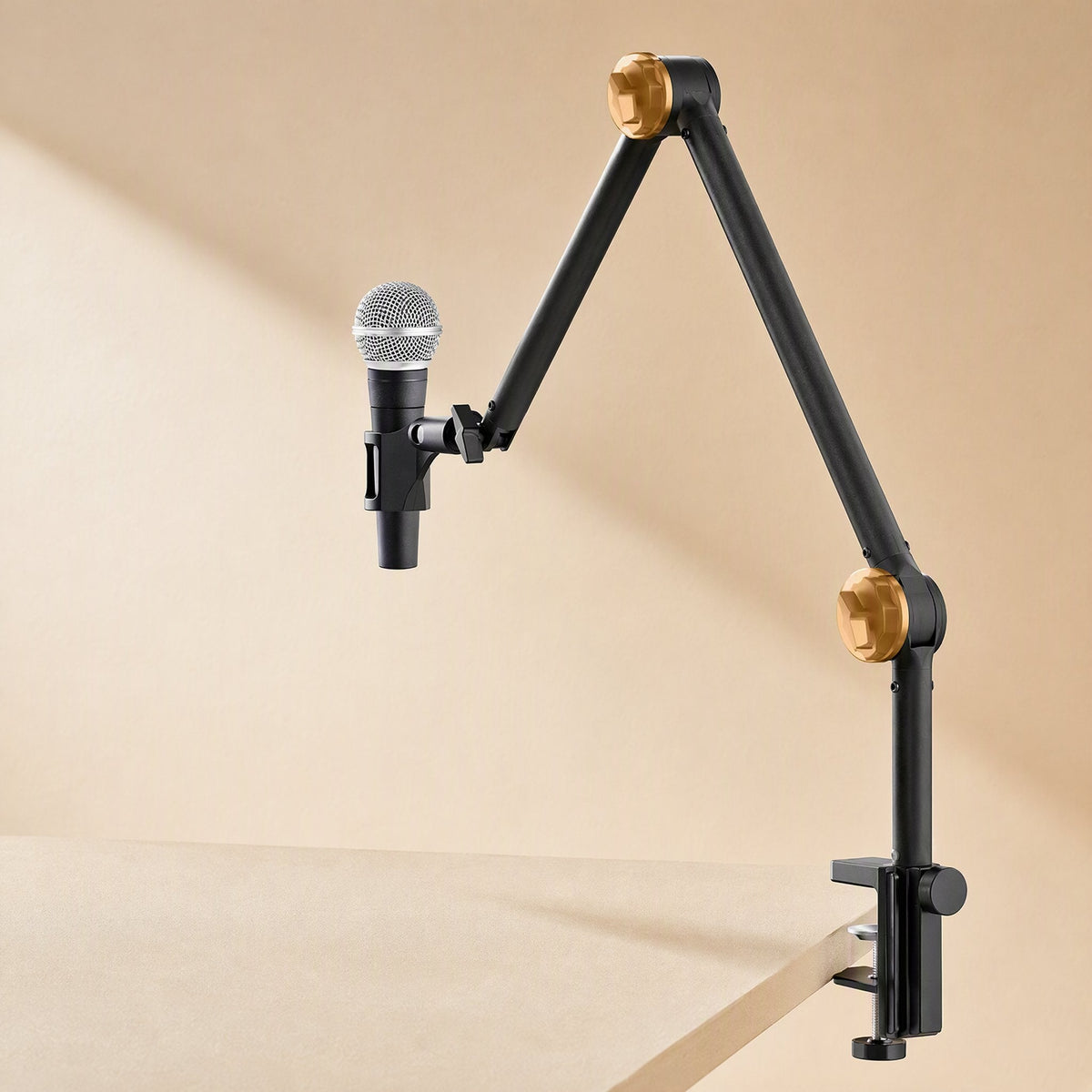Metalreach – Mic stand clamped to a tabletop edge holding a handheld microphone, with gold-toned joint knobs on the arm