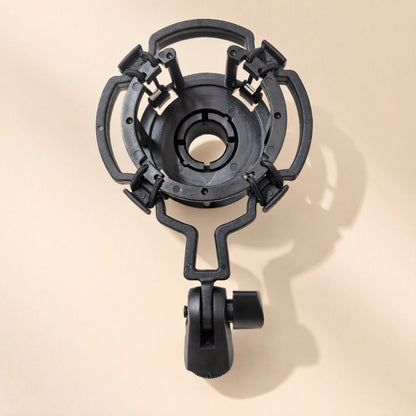 Joltclip – Black suspension shock mount with a round cradle, elastic-held arms and a thumbscrew stand adapter, top-down view