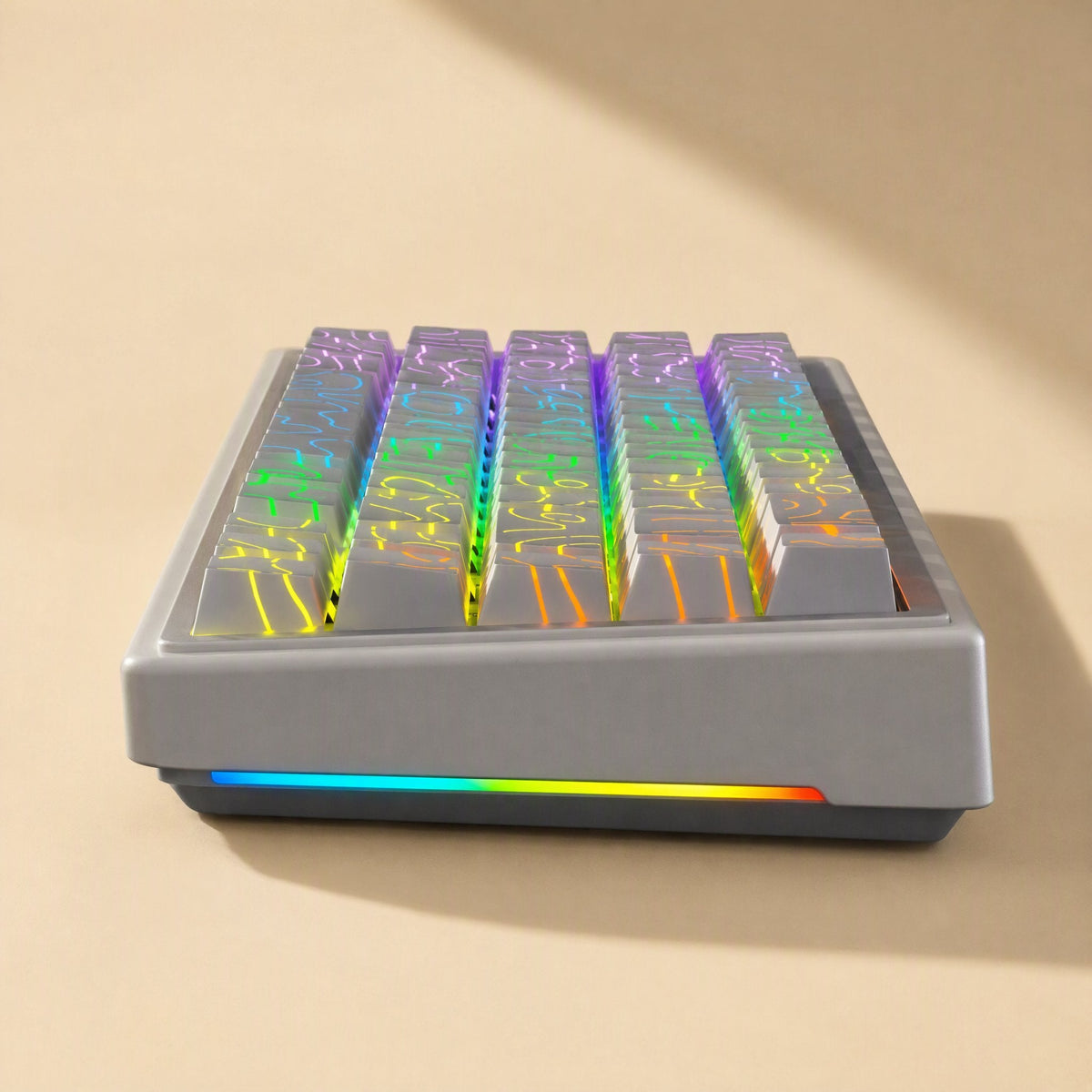 Sidescript – Side view of a gray keyboard with translucent keycaps showing rainbow contour lines lit by RGB backlighting