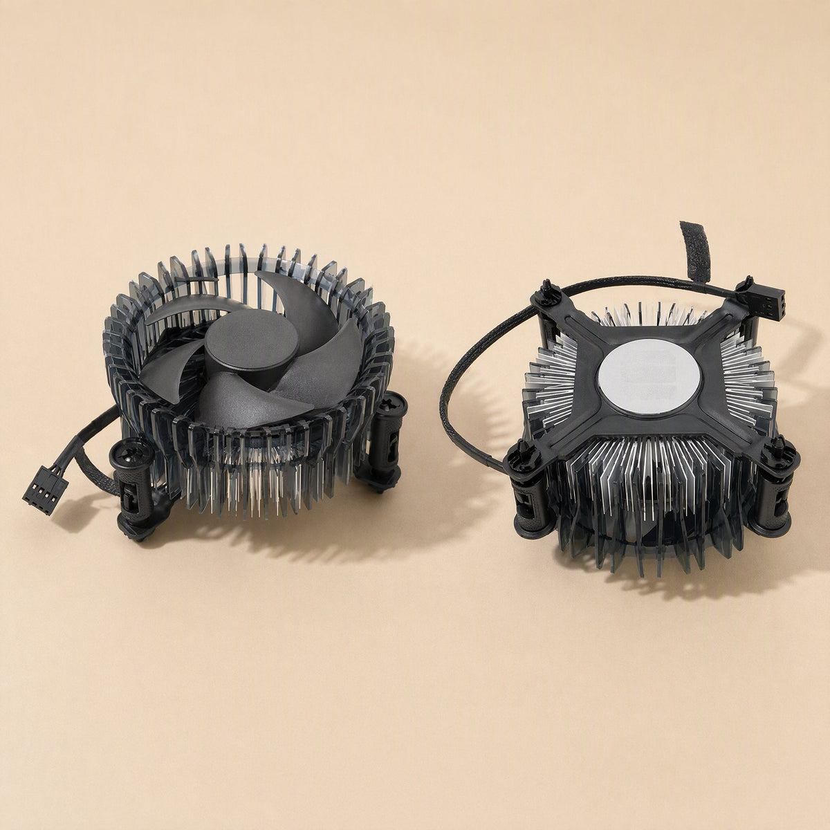 Socketcool – Two low-profile coolers side by side, one showing fan blades and cable, the other its round aluminum base plate