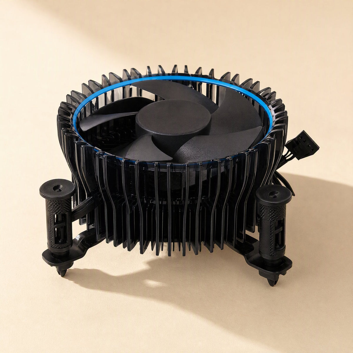 Socketcool – Large black cooler with blue ring around the fan, push-pin mounts and 4-pin connector on a beige surface