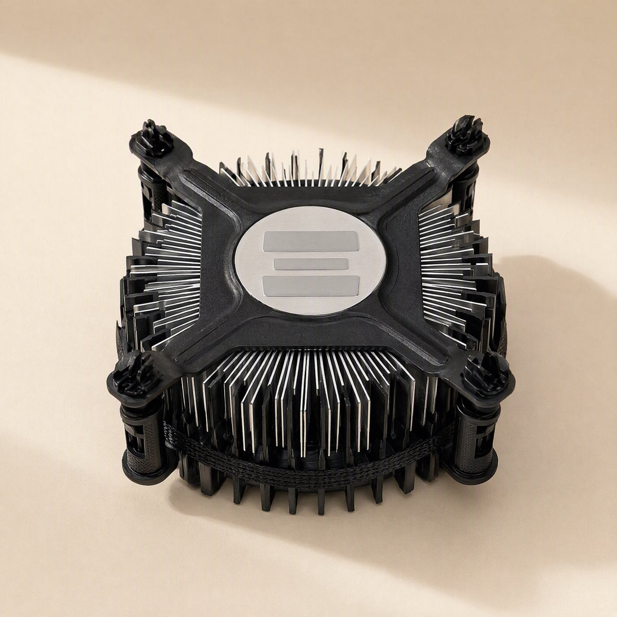 Socketcool – Underside of a black cooler showing the round base plate with pre-applied thermal pads and cross-shaped bracket