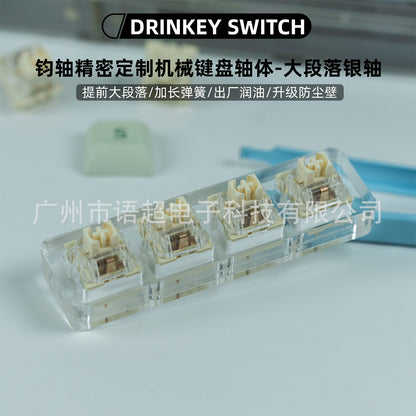 Silverclack mechanical keyboard switch, four cream switches with clear tops in an acrylic tester block