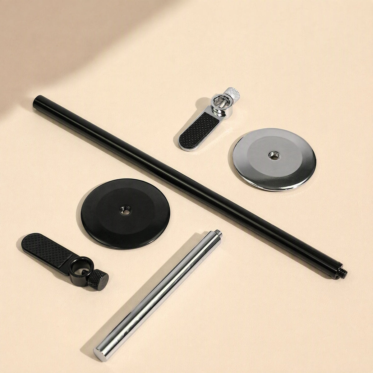 Magbrace – Disassembled bracket parts: black and silver posts, round bases, and support arms with thumbscrews