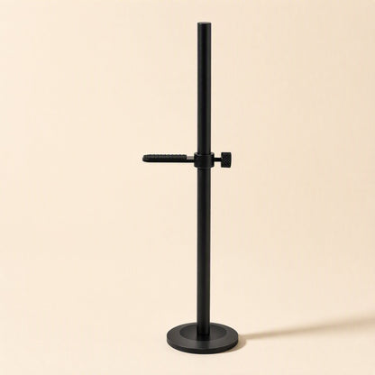 Magbrace – Black bracket with one textured arm and thumbscrew mounted on a round base, front view