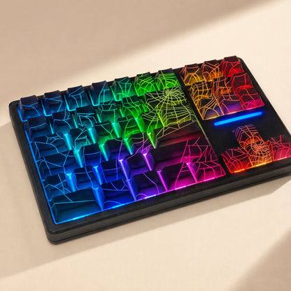 Webweave – Close view of spider web keycaps glowing blue, green, orange and pink on a black keyboard