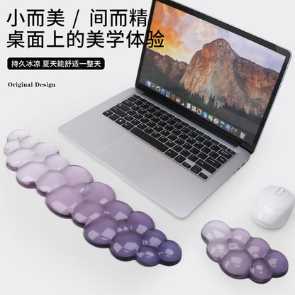 Restcloud Rubber Wrist Rest Pad – long and small purple cloud wrist rests placed in front of an open laptop and a white mouse