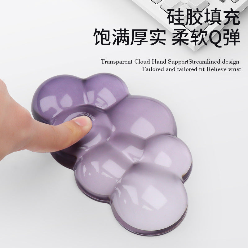 Restcloud Rubber Wrist Rest Pad – finger pressing into the soft surface of a translucent purple cloud-shaped wrist rest