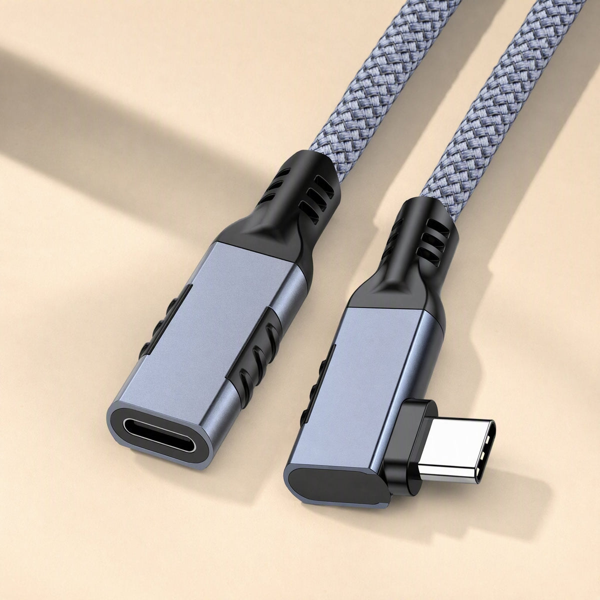 Elbowreach – Gray braided right-angle Type-C extension cable with female end and angled male plug on a cream surface