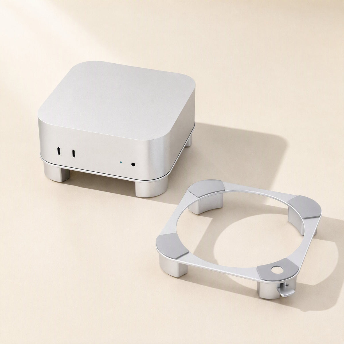 Miniperch Mac Mini Stand in silver aluminum beside a Mac Mini on its matching ring stand