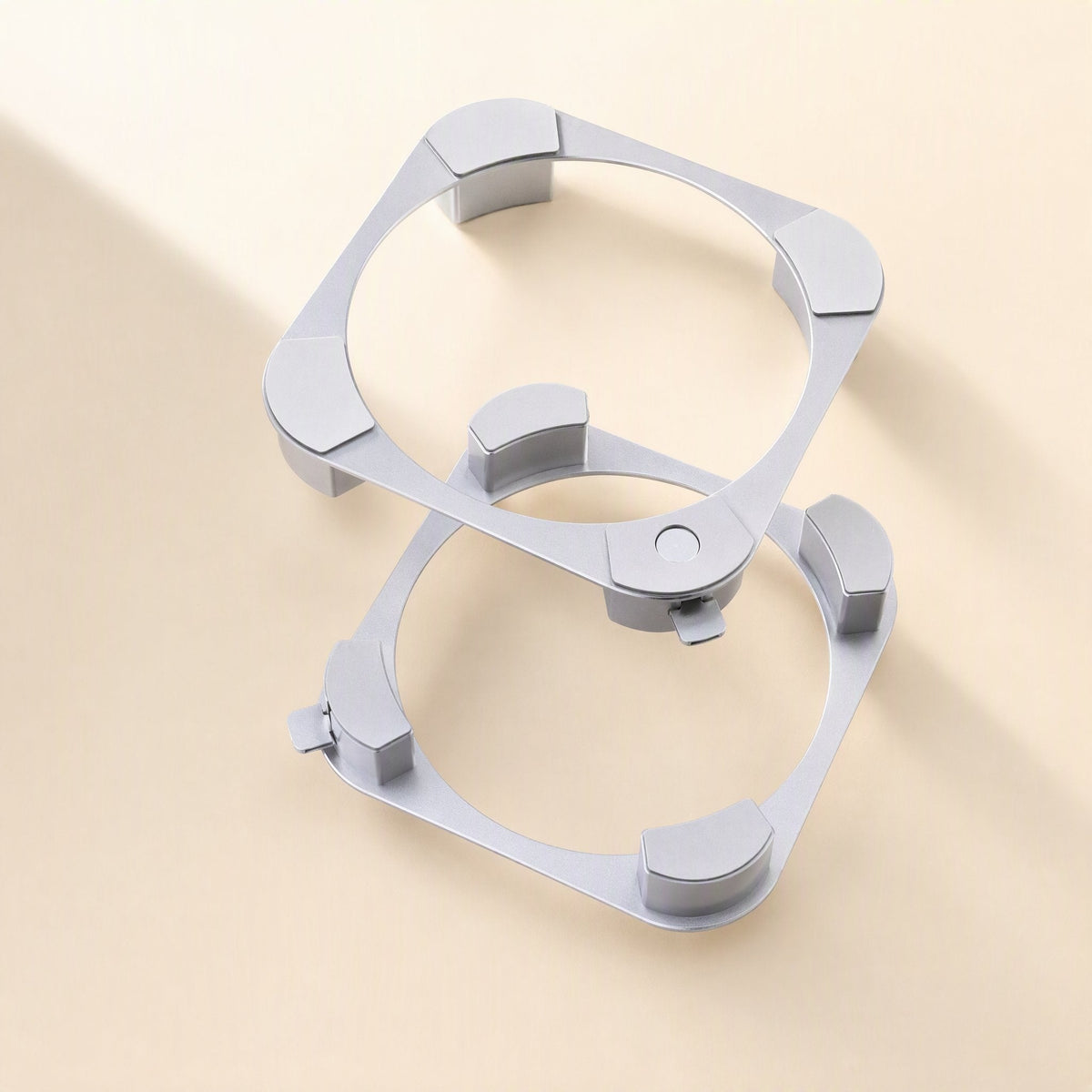 Miniperch – Two silver aluminum ring stands stacked at an angle, each with four curved feet and a small side tab