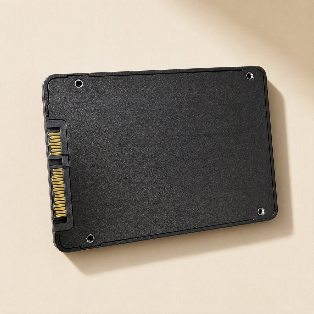 Satadrive 2.5-Inch SATA SSD – back of the black drive at an angle, showing gold SATA connector pins and four screw holes
