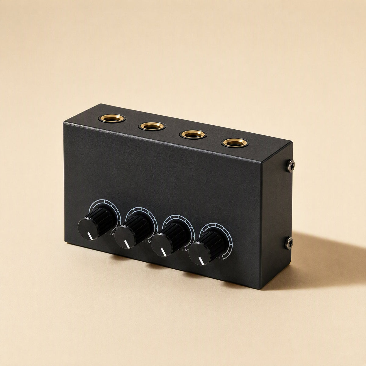 Ampwave – Black four-channel amplifier from the front left, showing gold-ringed headphone jacks on top and four knobs
