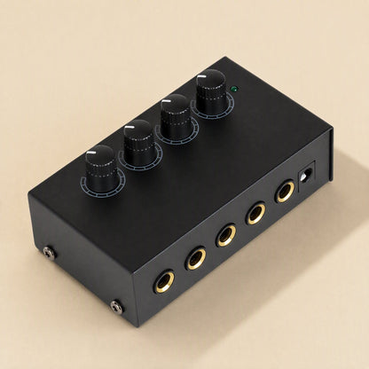 Ampwave – Black amplifier at an angle showing four knobs, green LED, front gold headphone jacks and power port