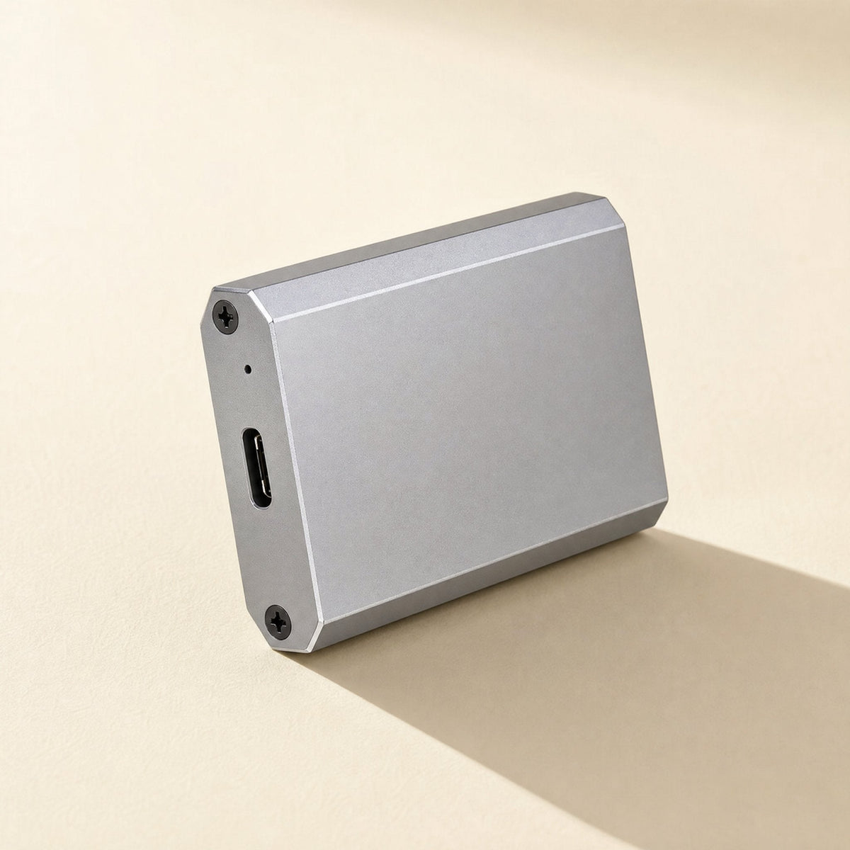 Bytehusk – Silver aluminum enclosure standing upright, showing the USB-C port, screws and a small indicator hole