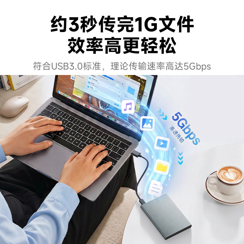 Alumacase – Hands typing on a laptop connected by cable to a gray drive enclosure, with 5Gbps transfer icons floating above