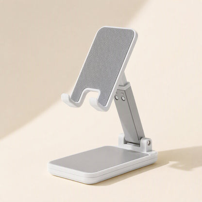 Foldcradle – Single white stand with adjustable arm raised and gray textured pad on a cream background