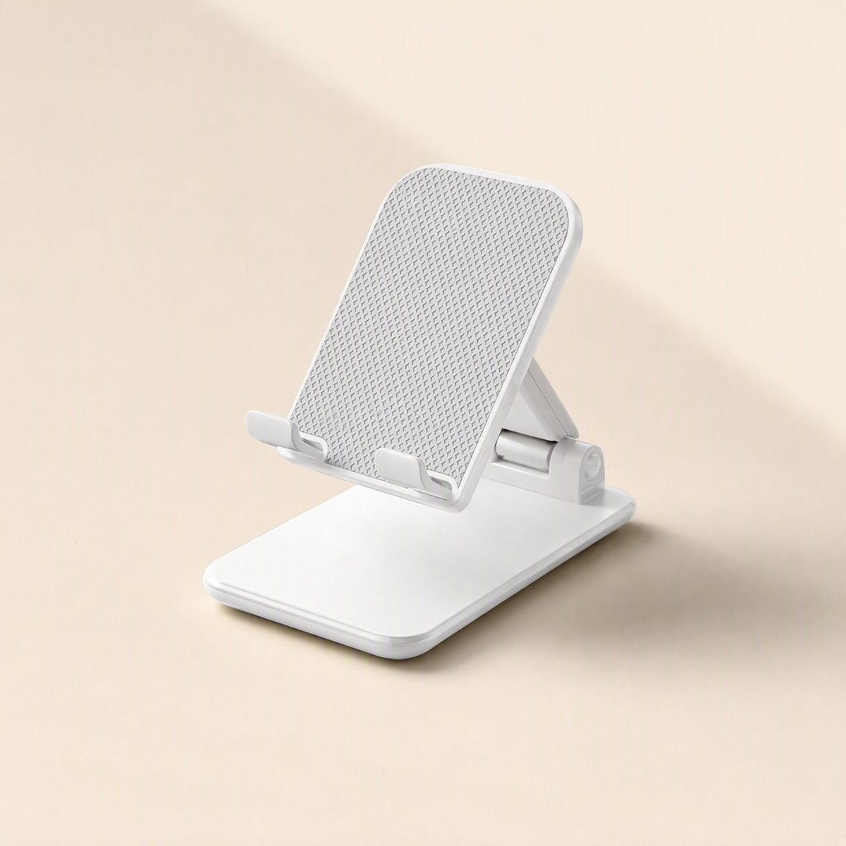 Foldcradle ABS Foldable Phone Stand – white phone stand from the front with a dotted grip surface and a low, angled tilt
