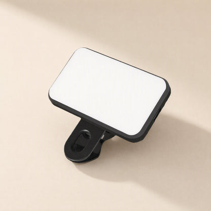 Snapshine – Black rectangular LED panel with rounded corners and a clip underneath, seen from above at a slant