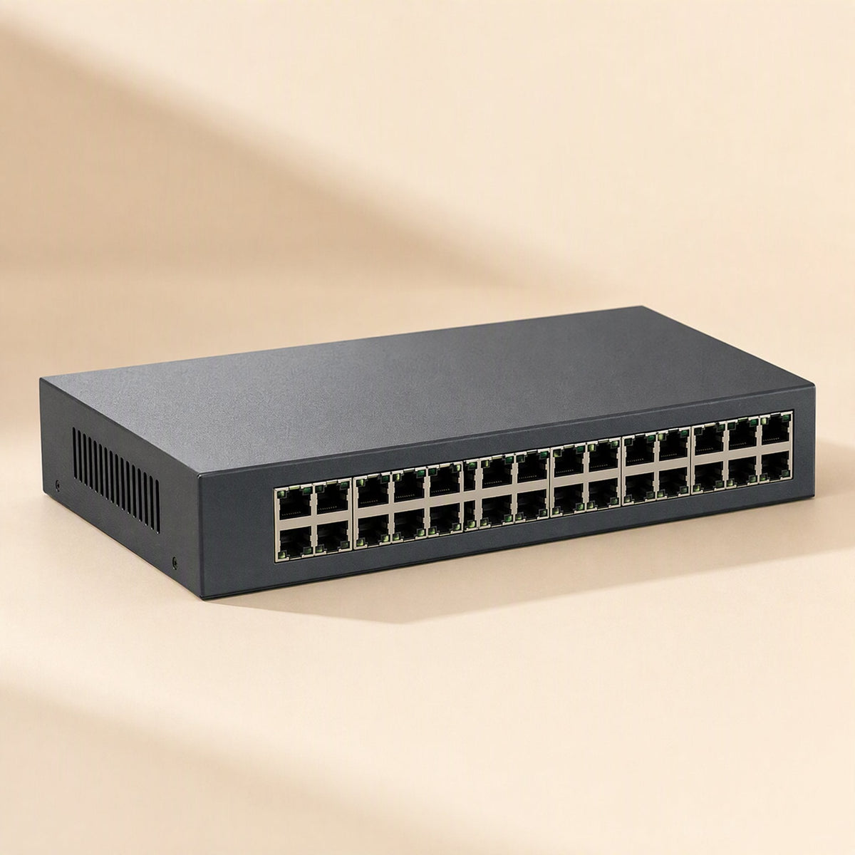 Netfork – Angled view of a dark gray 24-port switch with ventilation grille on the left side