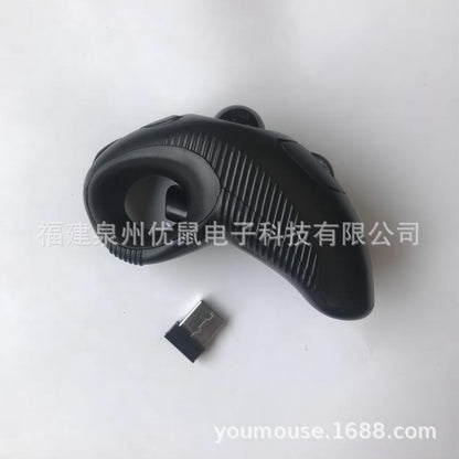 Trackorbit – Side view of the black trackball mouse showing the ridged grip and the finger loop, with USB receiver nearby