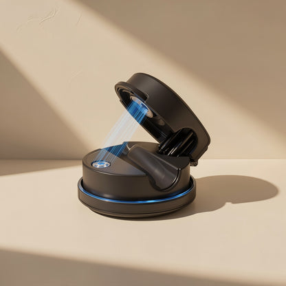 Spinloop – Black round holder with lid open, blue light glowing around the base, on a beige surface