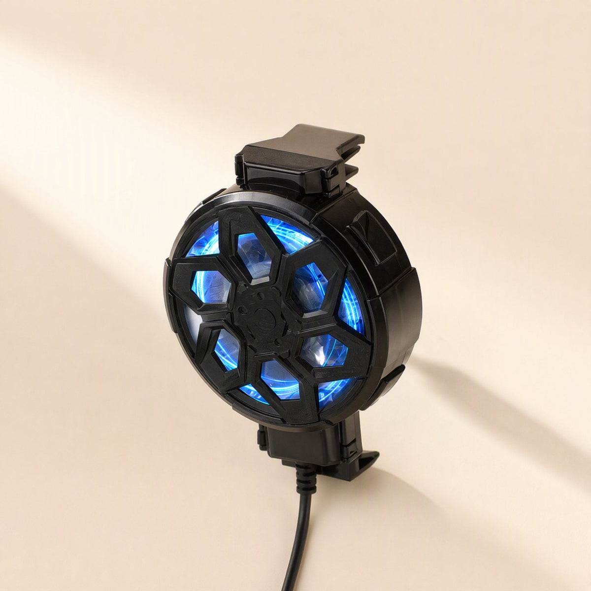 Frostclip – Upright clip with blue light glowing through the grille, spring clamps at top and bottom, cable below