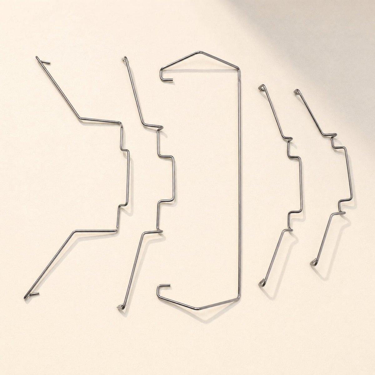 Fanlatch Steel Wire CPU Radiator Fan Buckle set of five wire clips laid out on a cream background
