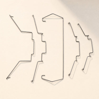 Fanlatch Steel Wire CPU Radiator Fan Buckle set of five wire clips laid out on a cream background