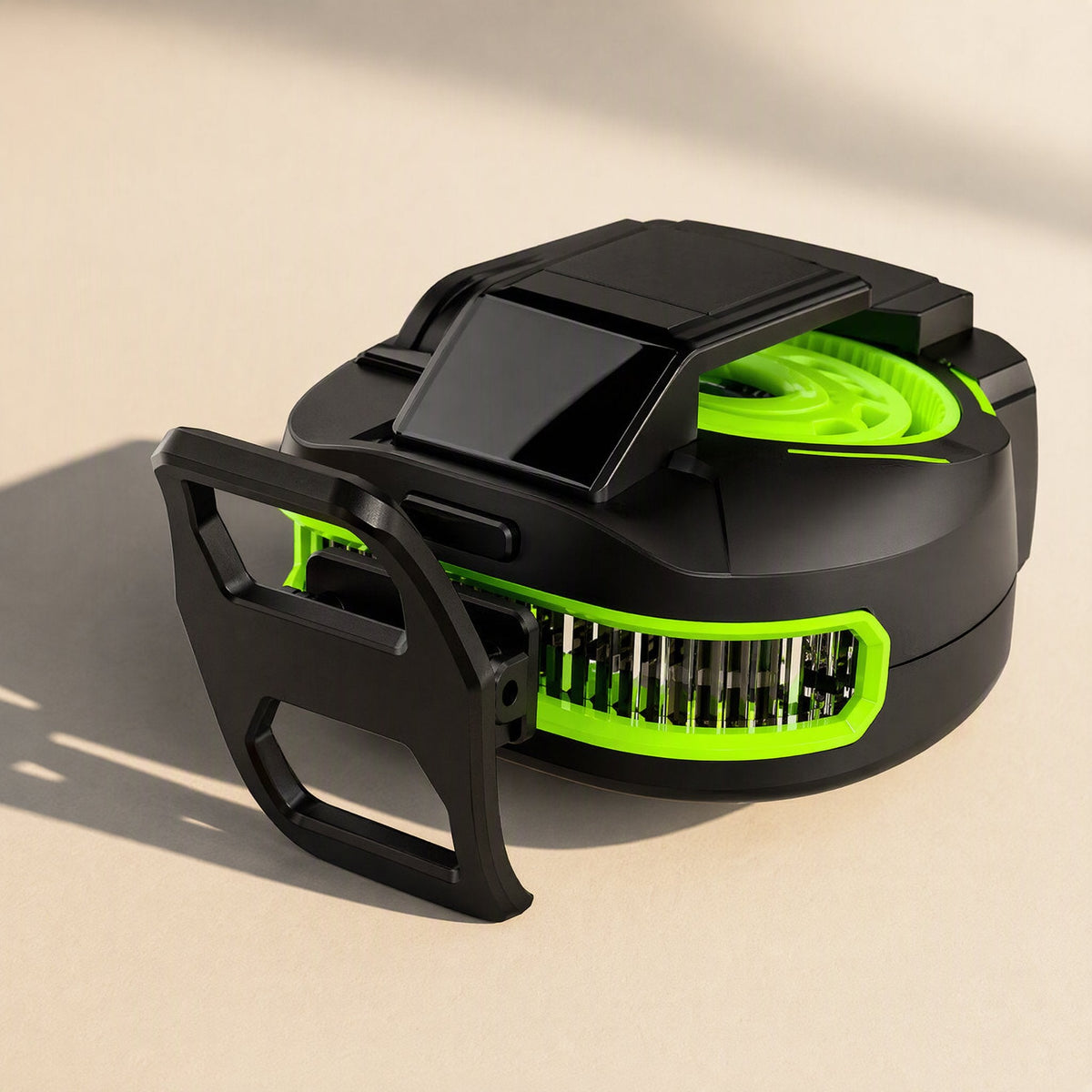 Coolcore – Rear view of the black and green cooler with a large folding clip arm and slotted air vents on the side