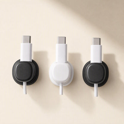 Spincoil – Three wall-mounted clips in black, white and black, each holding a white USB-C cable
