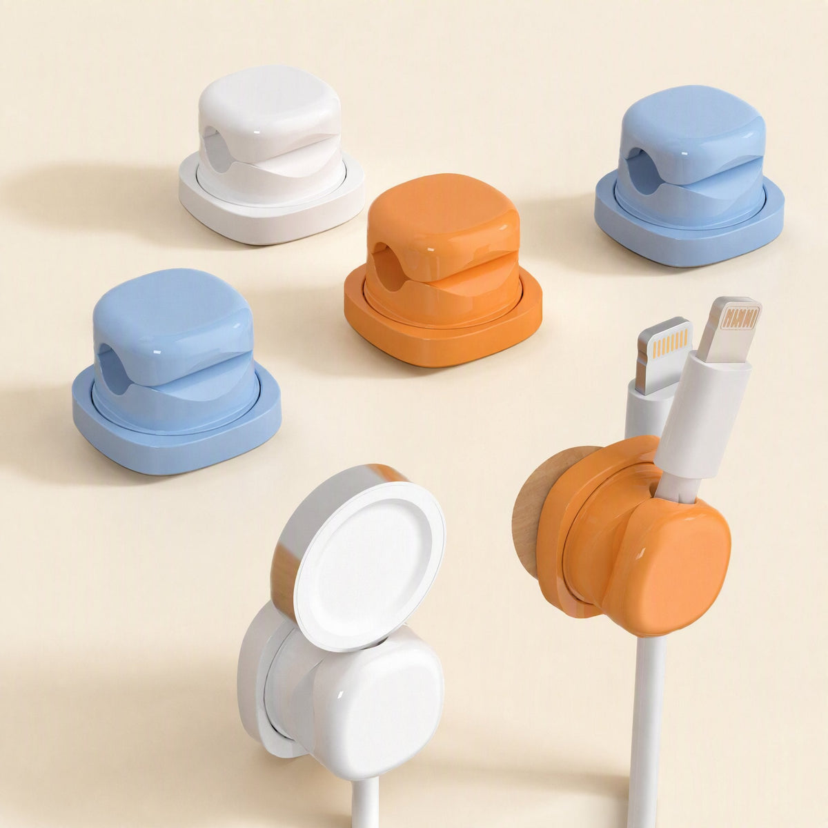 Spincoil – Five clips in white, blue and orange, with two turned to show the round back and a cable held in one