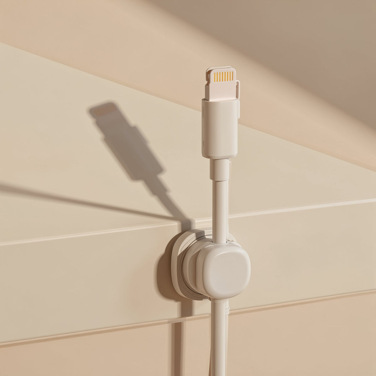 Spinsteady – Beige organizer mounted on a wall holding a white Lightning cable upright with its connector on top