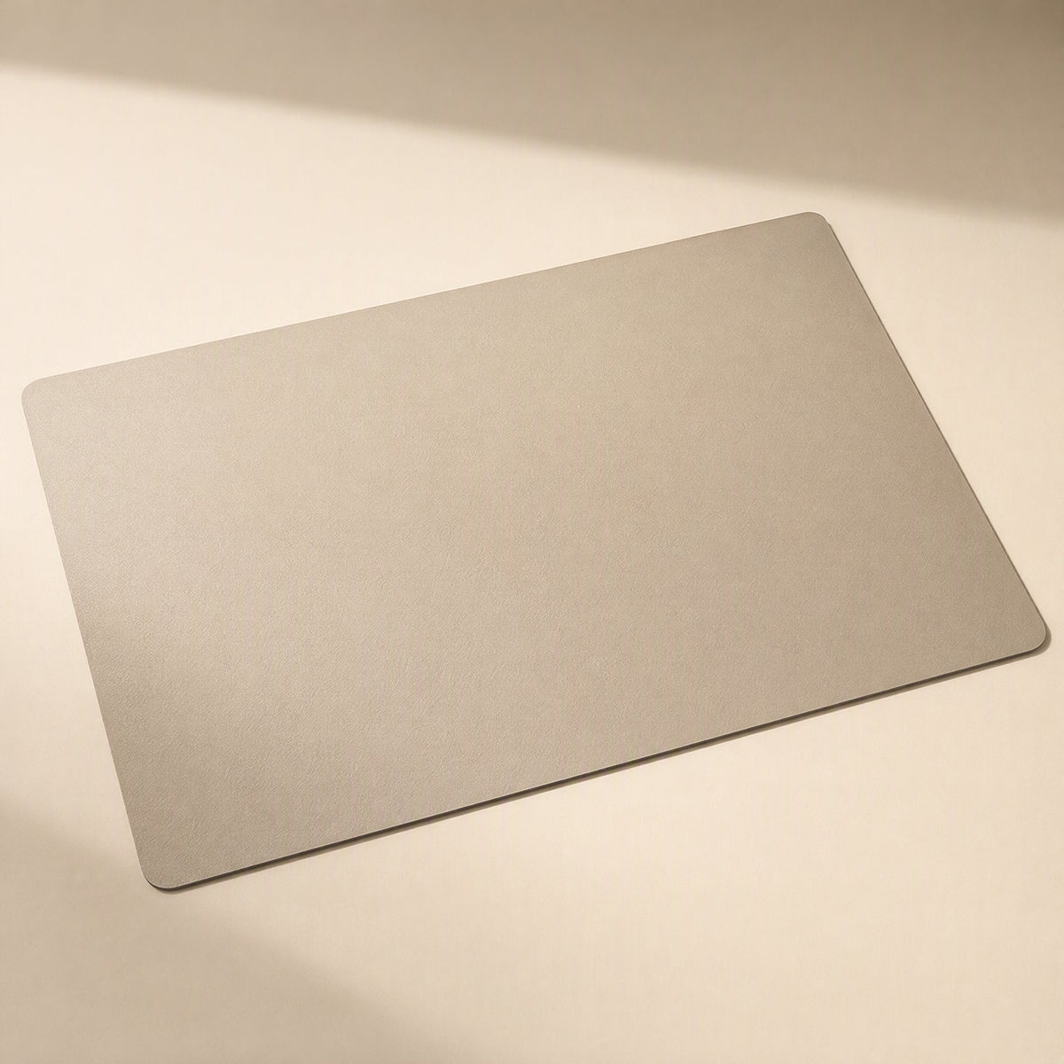 Smoothpad PU Leather Desk Mat – rectangular desk mat in light taupe with rounded corners on a cream background