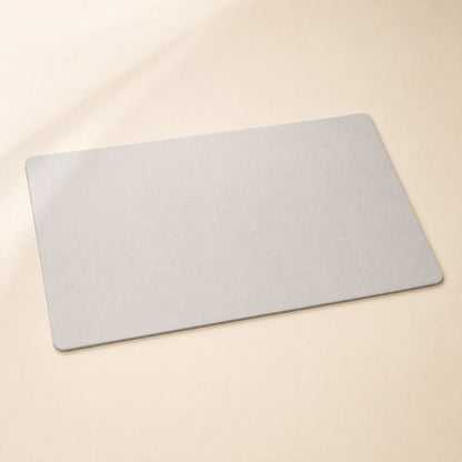 Smoothpad PU Leather Desk Mat – light grey desk mat with softly rounded corners, photographed from above at an angle