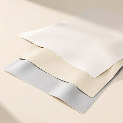 Smoothpad PU Leather Desk Mat – three desk mats in white, beige and light blue-grey stacked with gently waving edges